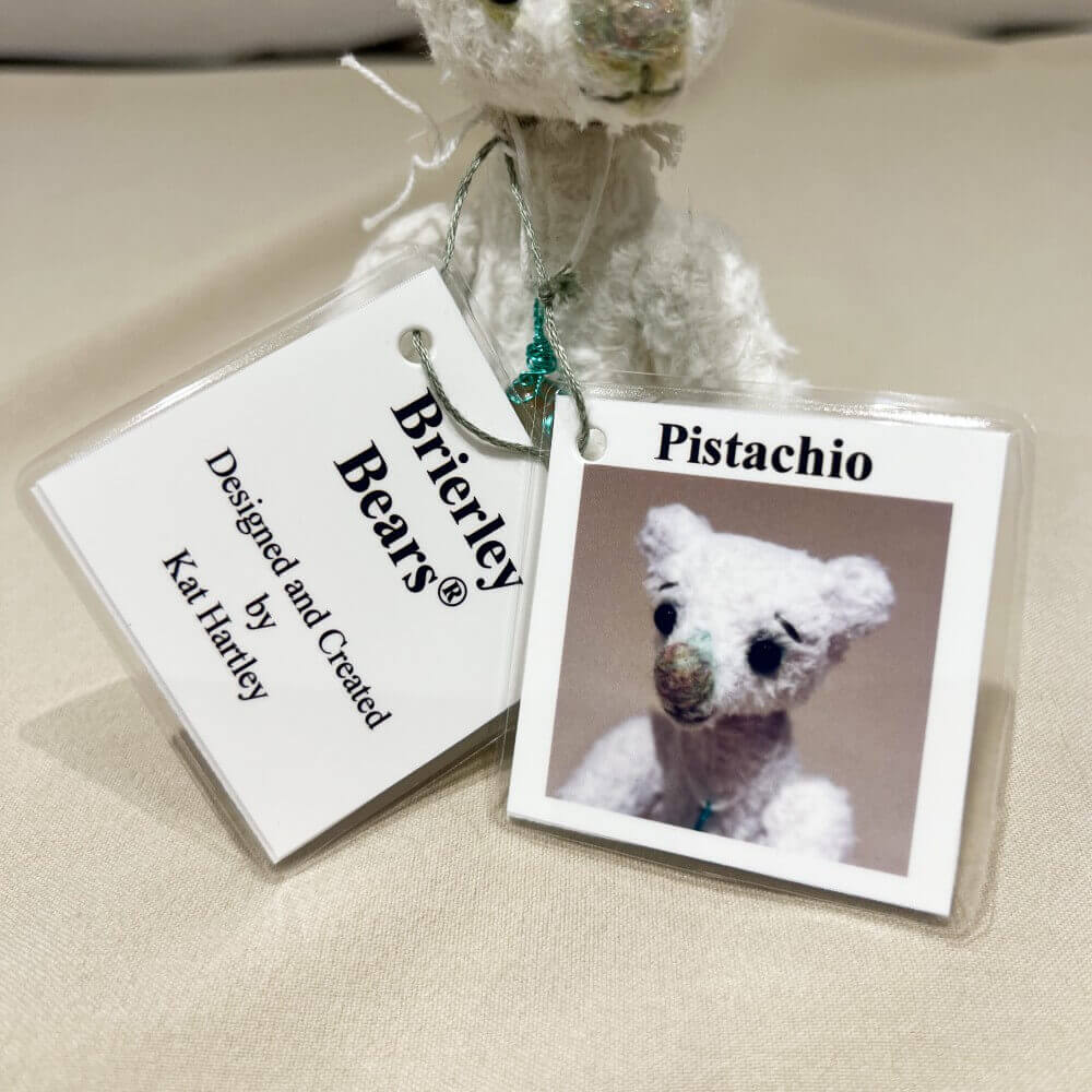 Front of individually designed identity hang tags for Pistachio by Brierley Bears