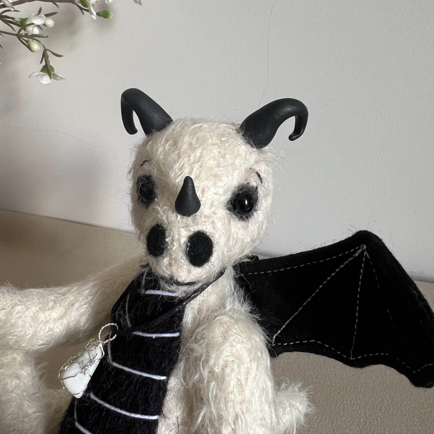 White and black mohair baby dragon, handmade by Brierley Bears. Head shot